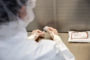 compounding pharmacist preparing vial