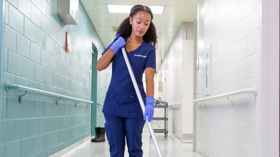 Woman cleaning hallway